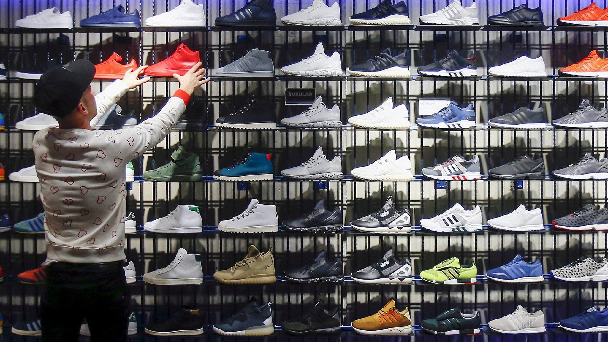 FILE PHOTO: A shop assistant works at the Adidas flagship store in Berlin