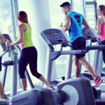 Group of people running on treadmills