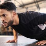 Fitness, training and push up with man in gym for training, muscle and workout endurance